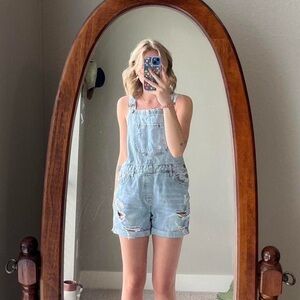 Light wash distressed denim overall shorts from C’est Toi Black Label